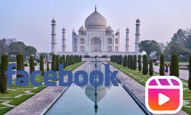 El Taj Mahal se alza en el centro, detrás de un largo estanque reflectante, con un gran texto azul que dice "facebook" superpuesto cerca del estanque y un colorido icono de Reels en la parte inferior derecha; jardines y un cielo pálido.