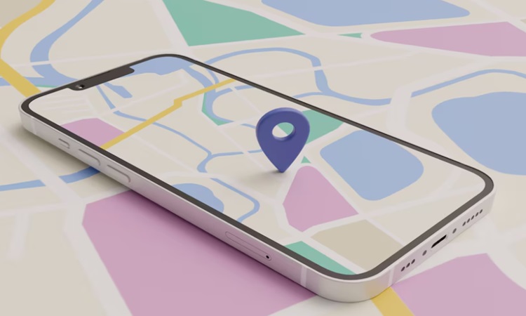 El teléfono inteligente muestra un mapa digital colorido; un marcador azul señala un punto en la pantalla, con calles, manzanas y vías fluviales abstractas en tonos pastel visibles en el fondo circundante.